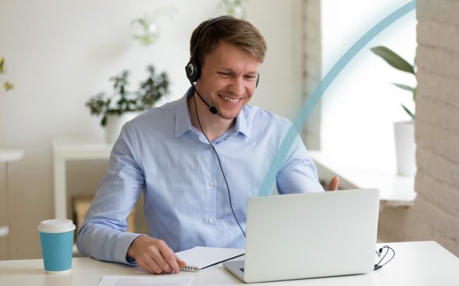 Man viewing a virtual meeting on a laptop