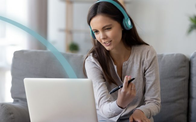 Lady engaging in a virtual meeting on a laptop working from home